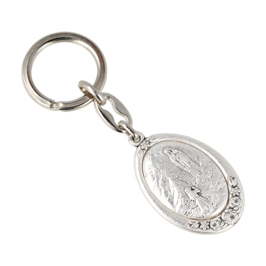 Keychain Our Lady of Lourdes Oval Silver with Flowers. Souvenirs from Italy